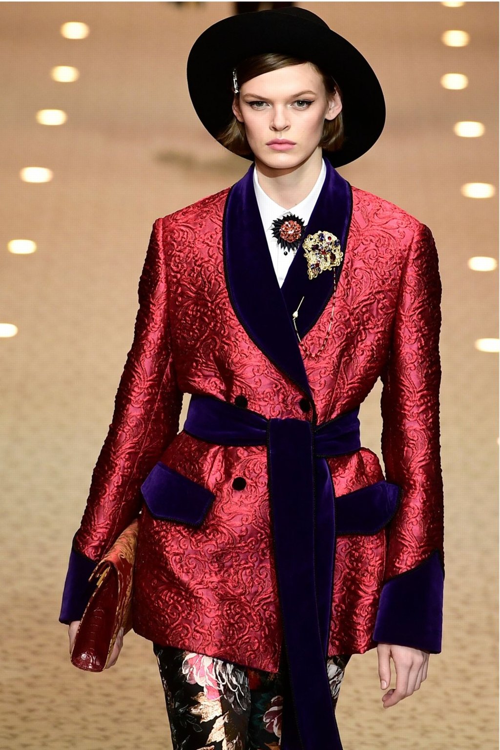 This bright red jacket’s material creates a contrast in texture with its velvet collars, sleeves and pockets and waist tie. Photo: AFP This bright red jacket’s material creates a contrast in texture with its velvet collars, sleeves and pockets and waist tie. Photo: AFP