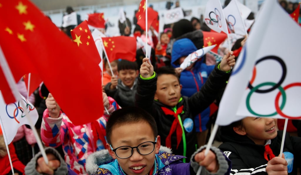 Children wave Chinese and Olympic flags during a ceremony marking the start of the tour of the Olympic flag leading up to the Beijing 2022 Olympic and Paralympic Winter Games. Photo: Reuters