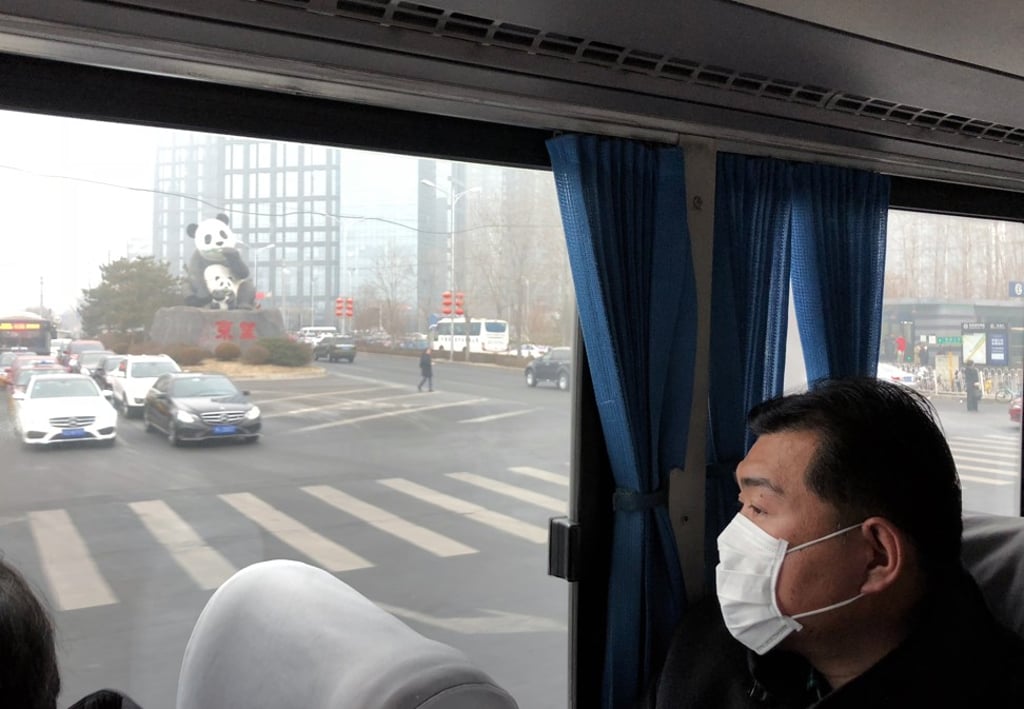 A passenger wears a mask as he takes a bus in Beijing on Tuesday, when air pollution reached “dangerously high levels”. Photo: Simon Song