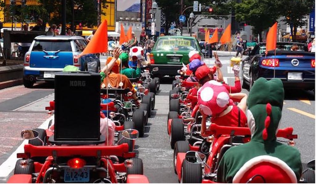 Tourists dressed as Toad, Yoshi, Mario and other characters in the ‘Mario Karts’ on the streets of Tokyo. Photo: handout