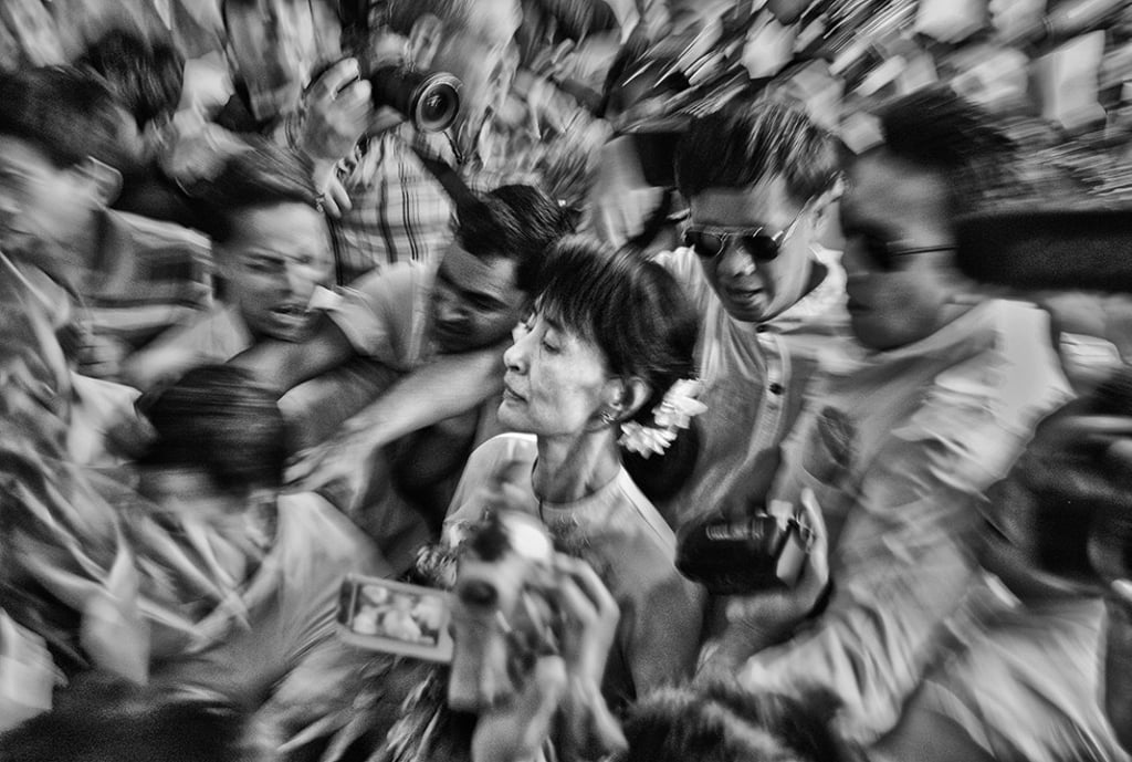 Myanmar's leader Aung San Suu Kyi makes her way through the crowd as she arrives at the National League for Democracy headquarters in Yangon on the day following her election. Picture: Minzayar Oo