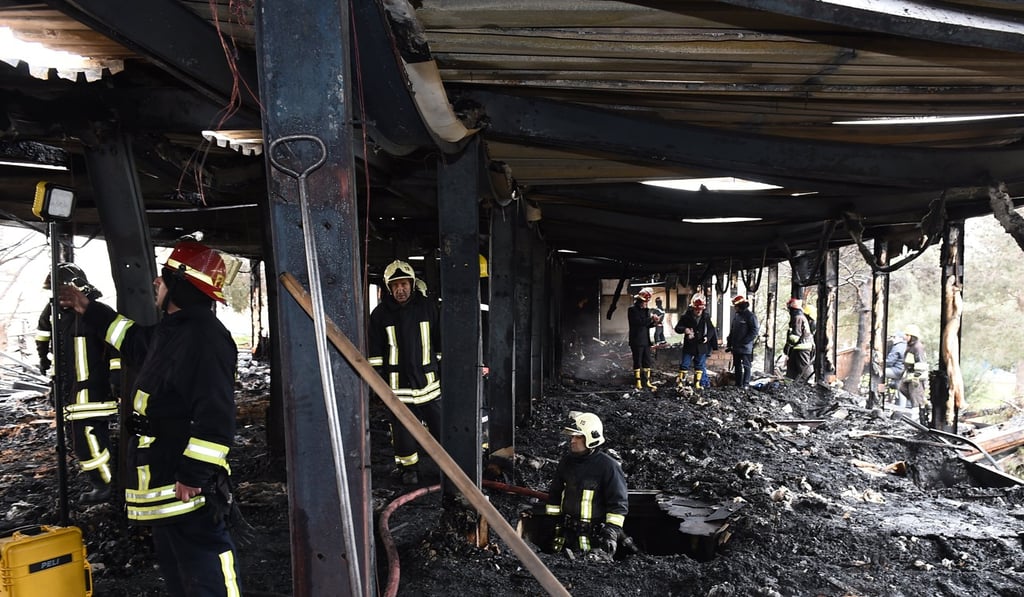 Azerbaijani firefighters at the site of a fire in the republican drug rehabilitation centre in Baku, where 24 people died. Photo: EPA