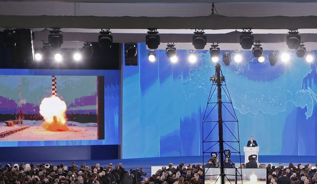 Russian President Vladimir Putin delivers his annual address to the Federal Assembly, showing animations of new nuclear weapons developed by the government. Photo: EPA