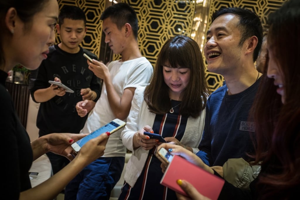 Chinese social media users add each other on the WeChat app on their mobile phones. Photo: EPA