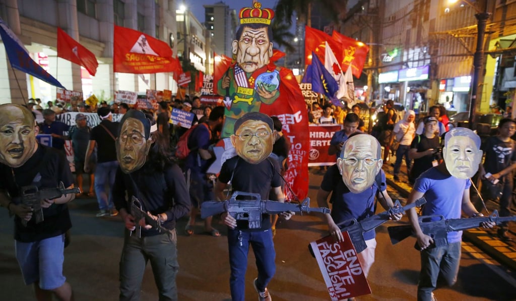 Protesters, wearing masks of President Rodrigo Duterte's military generals in his cabinet, march towards the Presidential Palace to call for an Protesters, wearing masks of President Rodrigo Duterte's military generals in his cabinet, march towards the Presidential Palace to call for an