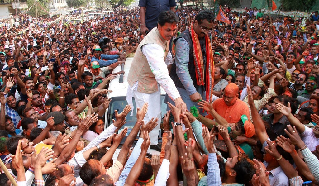 BJP state president of Tripura and chief ministerial candidate Biplab Kumar Deb (in white) and BJP general secretary Ram Madhav greet supporters after getting an absolute majority against the Communist Party of India (Marxist). Photo: EPA BJP state president of Tripura and chief ministerial candidate Biplab Kumar Deb (in white) and BJP general secretary Ram Madhav greet supporters after getting an absolute majority against the Communist Party of India (Marxist). Photo: EPA