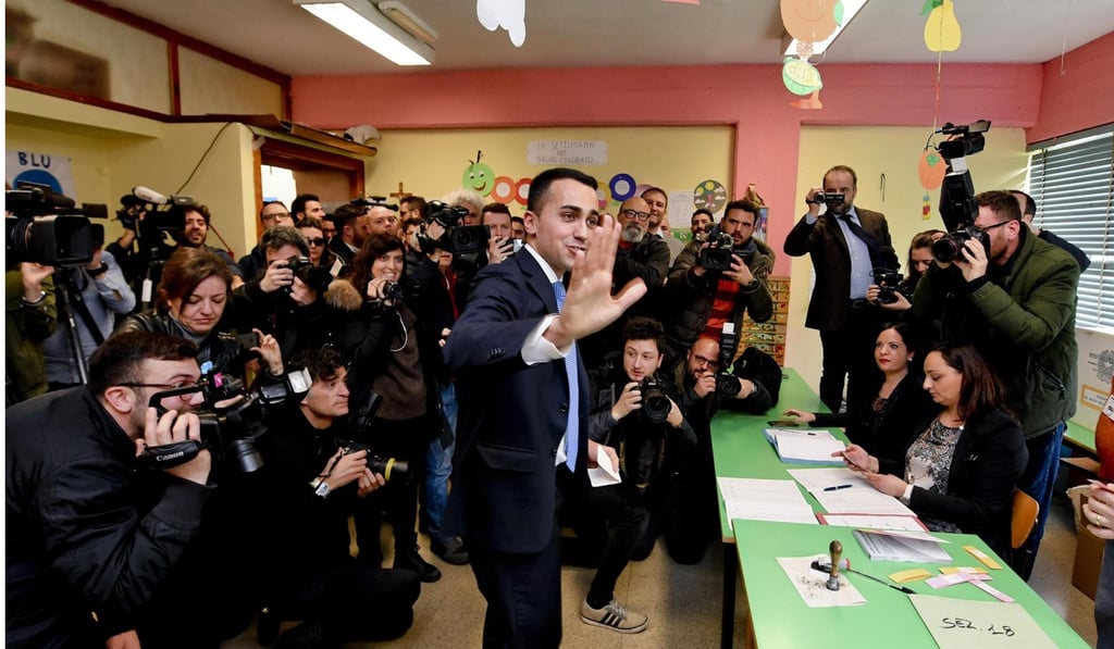 Luigi Di Maio, the Five Star Movement’s candidate, registers to vote at a polling station in Pomigliano d’Arco, near Naples. Photo: EPA