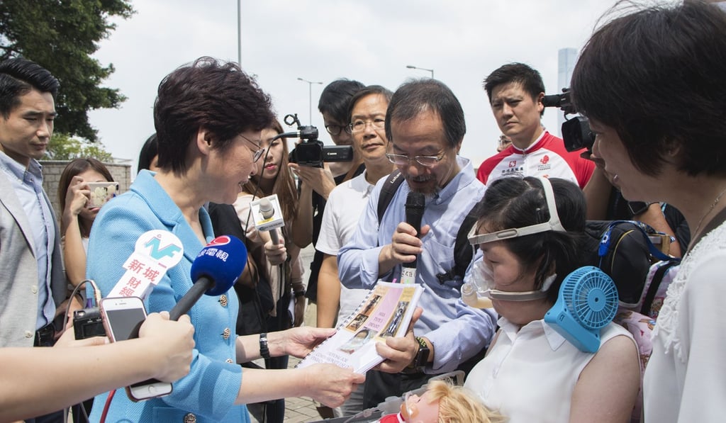 Chief Executive Carrie Lam meets Josy Chow, who suffers from spinal muscular atrophy, outside the government headquarters in Admiralty last October. Photo: Kwong Wing-kin
