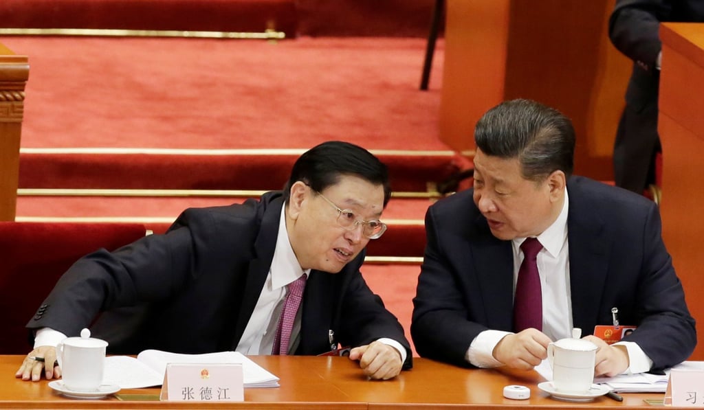 Xi Jinping (right) talks to Zhang Dejiang during the opening session of the annual parliamentary session on Monday. Photo: Reuters