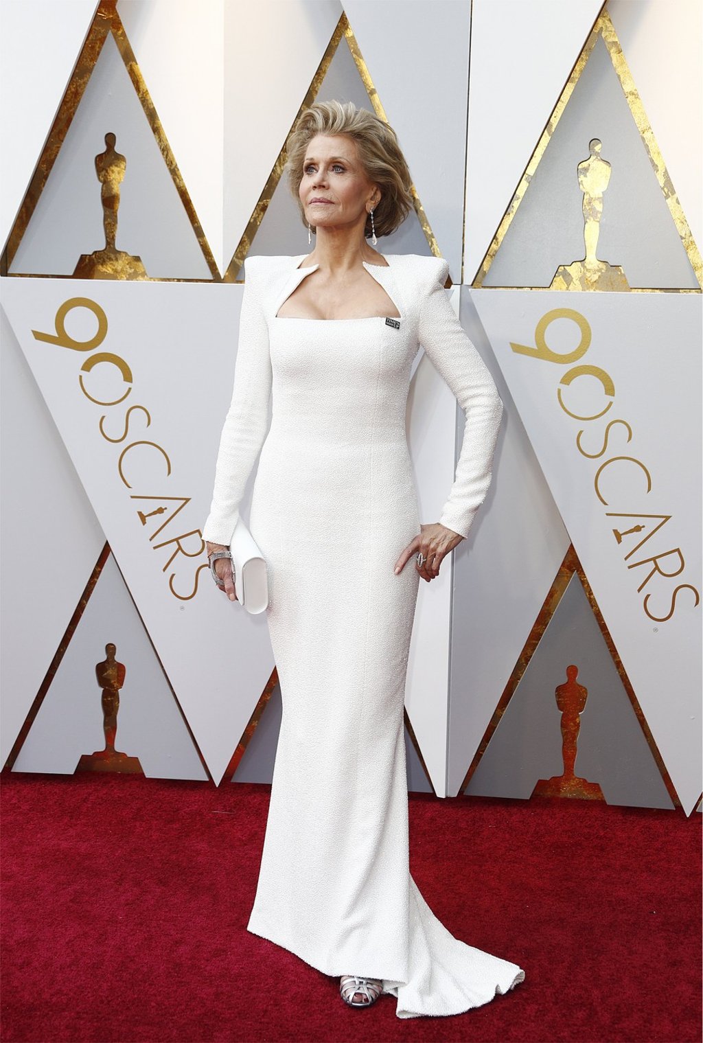 Jane Fonda embraced the ice princess look at 80 in a sculpted white Balmain gown with a geometric neckline. Photo: EPA
