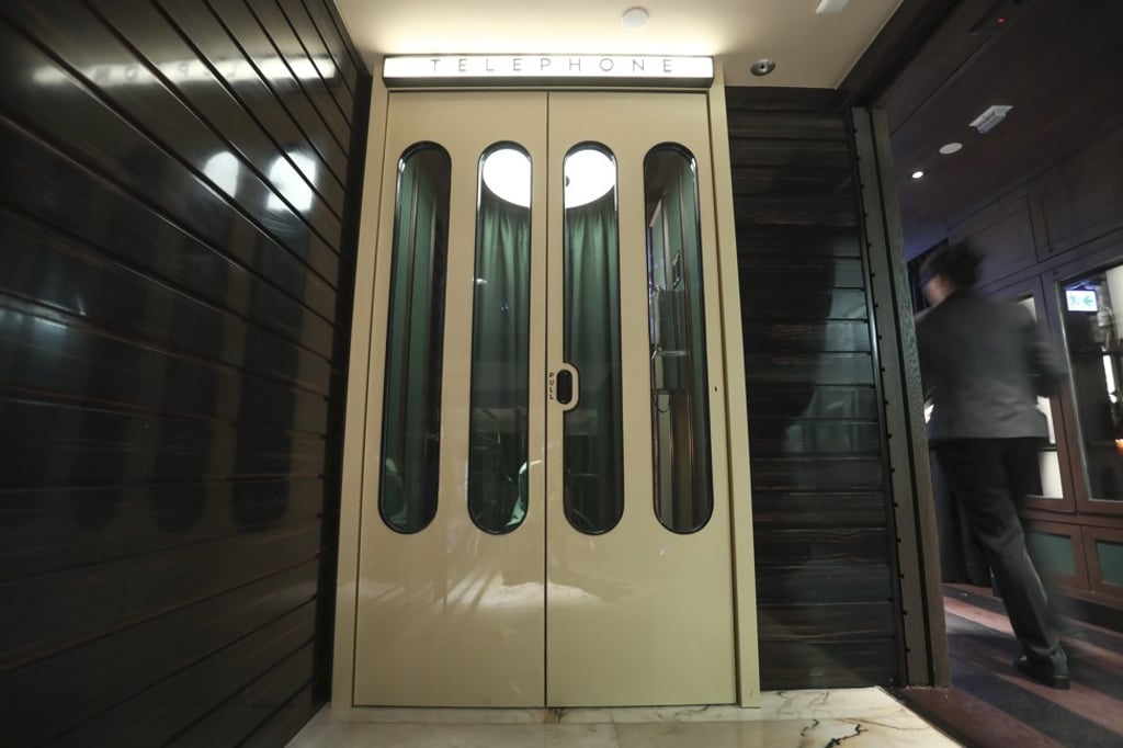 Entrance to the bar is through a phone booth. Photo: Jonathan Wong