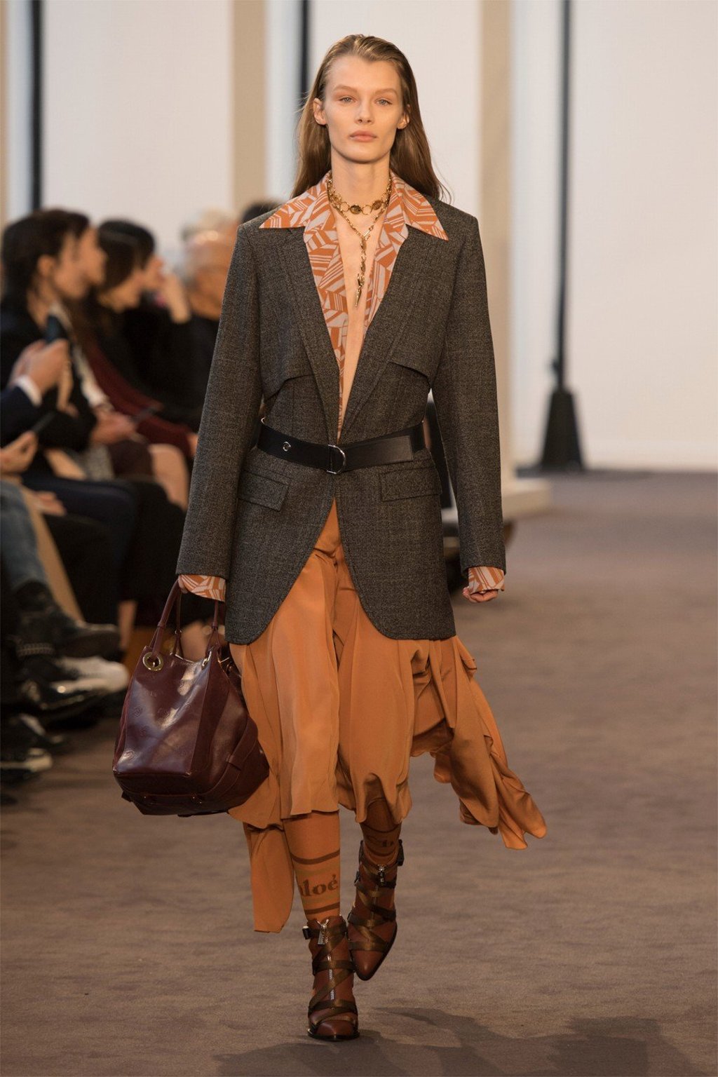 A flowing dress is paired with a suit jacket and socks featuring Chloé’s logo.