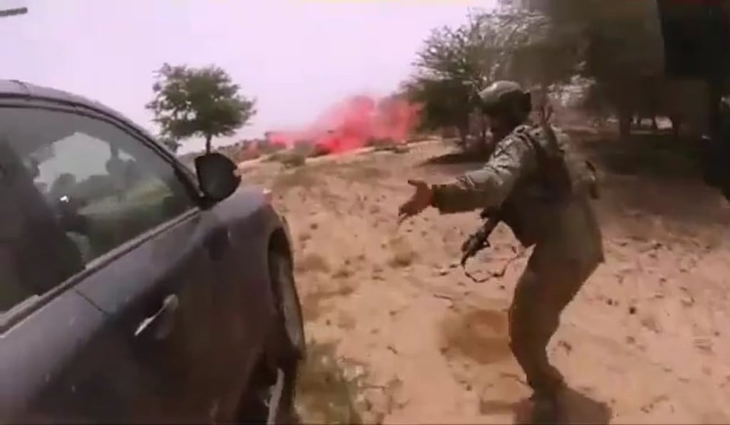 This video screen grab obtained March 5 shows the October 4, 2017, ambush of American and Nigerien soldiers in Tongo Tongo, Niger. The image appears to show US soldier La David Johnson using a moving SUV for cover. Johnson would die in the attack. Photo: Agence France-Presse