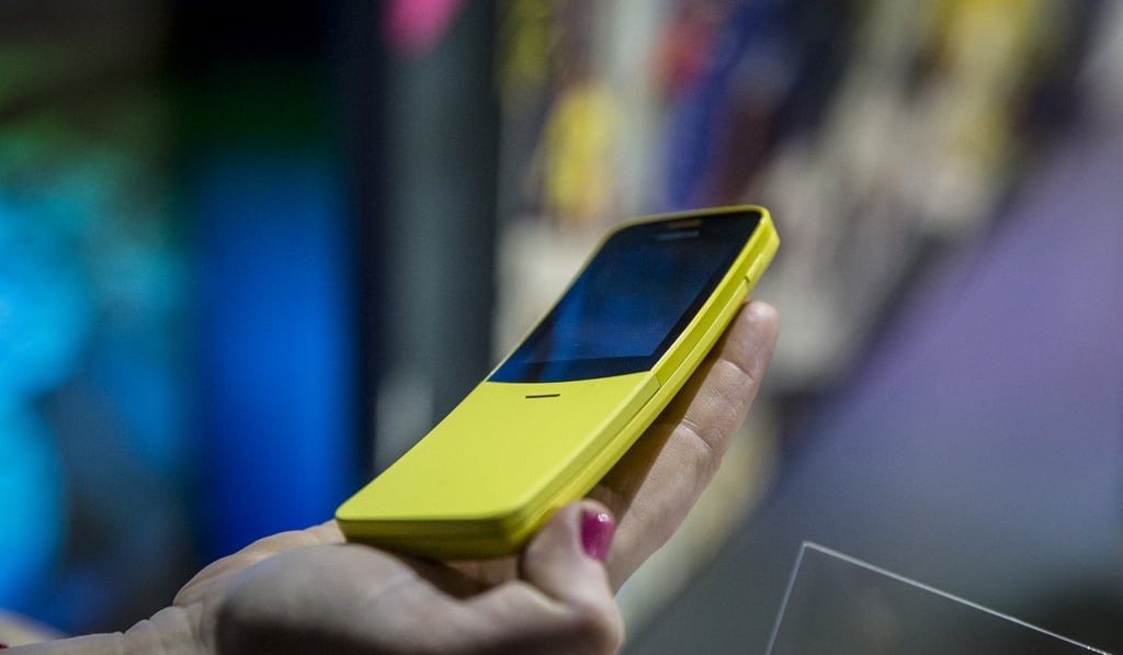An attendee holds a yellow Nokia 8110 4G smartphone during a launch event ahead of last month’s Mobile World Congress in Barcelona, Spain. Photo: Bloomberg