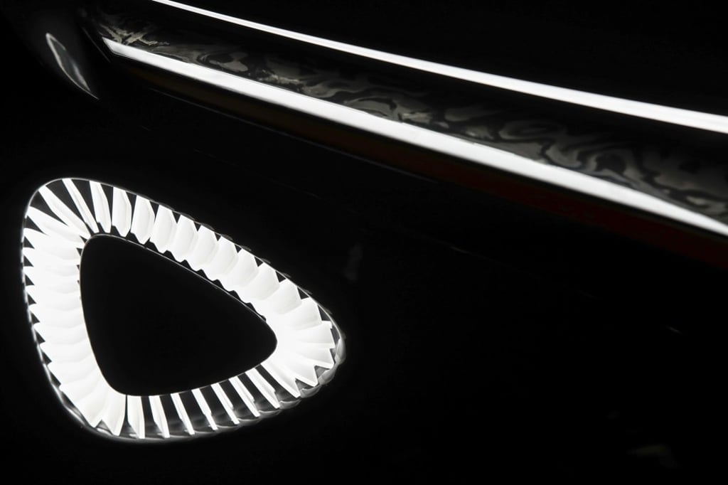 A headlight sits illuminated on the Aston Martin Lagonda car on display at the Geneva Motor Show. Photo: Bloomberg A headlight sits illuminated on the Aston Martin Lagonda car on display at the Geneva Motor Show. Photo: Bloomberg