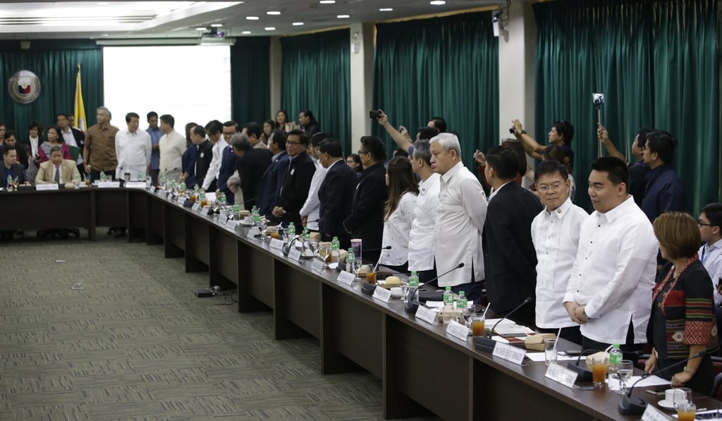 Members of the Philippine Congress stand to signify their vote Photo: AP Members of the Philippine Congress stand to signify their vote Photo: AP
