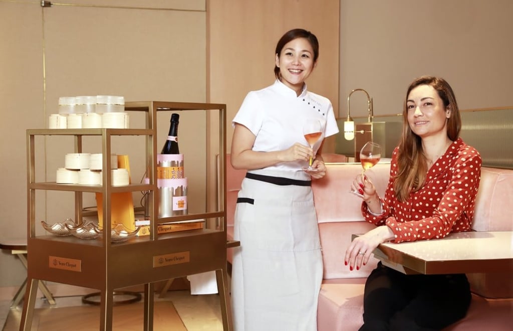 Chef Vicky Lau ,(left) of Tate Dining Room & Bar, and Gäelle Goossens, winemaker of Veuve Clicquot, alongside the Veuve Clicquot dim sum cart