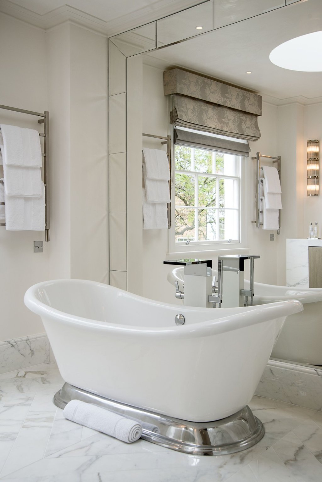In Egerton Crescent, one of Katharine Pooley's projects, a mirrored wall doubles the size of the bathroom.