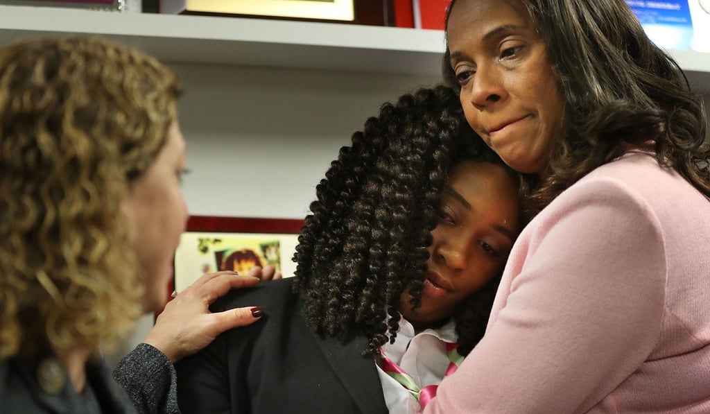 Marjory Stoneman Douglas High School mass shooting survivor Mei-Ling Ho-Shing, 17, is comforted by Rosalind Osgood, a Broward County School Board member after a gun safety round table discussion on March 5, 2018 in Sunrise, Florida. Photo: Getty Images/AFP