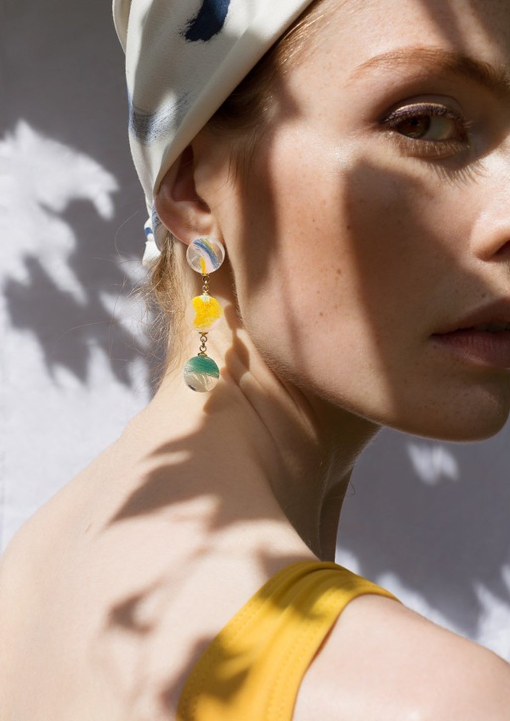 Pendant earrings handmade from coloured resin, designed by Zhang.