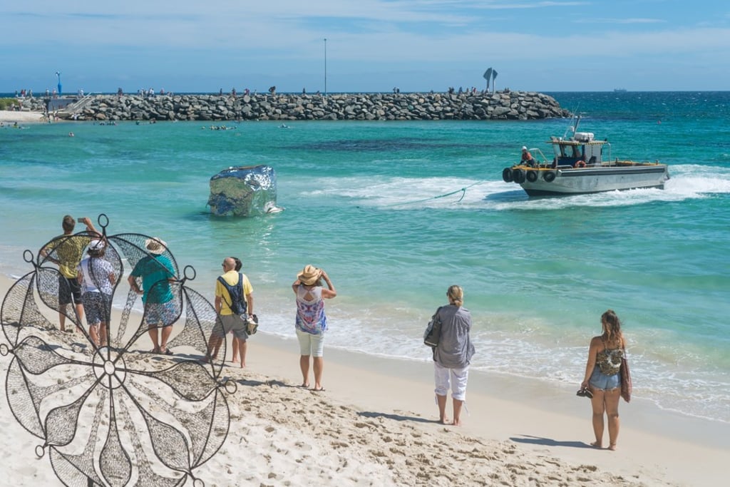 A boat pulls Floating Rock into position off Cottesloe Beach in western Perth. Picture: Richard Watson