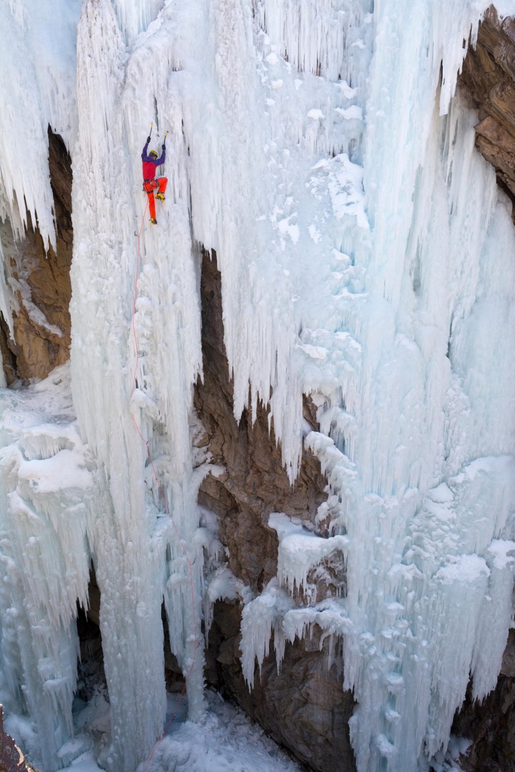 A climber ascending a frozen waterfall. Photo: Alamy