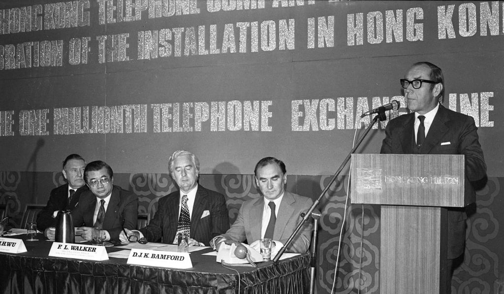 Chief Secretary Denys Roberts (right) marks the connection of the millionth phone line in Hong Kong. Photo: SCMP