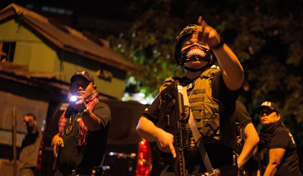 Philippine Drug Enforcement Agency agents and police secure part of a street as they search a house looking for a drug dealer south of Manila last month. President Rodrigo Duterte has given police chiefs subpoena powers to speed up criminal investigations. Photo: AFP