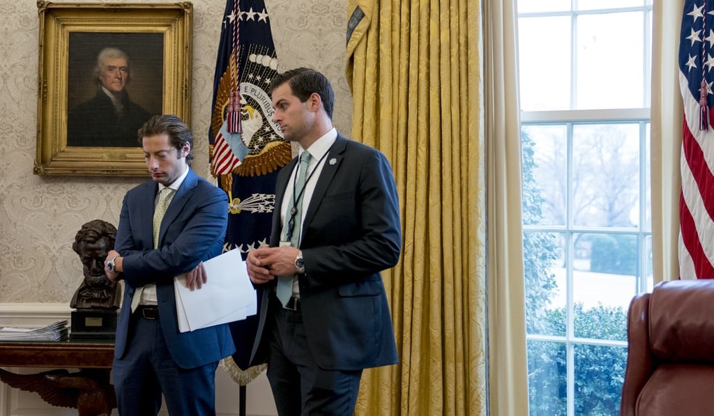 In this January 31, 2018 file photo, White House aide John McEntee, right, and Treasury Secretary Steve Mnuchin's Chief of Staff Eli Miller, left, stand in the Oval Office. Photo: AP