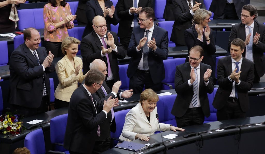 German Chancellor Angela Merkel receives applause after she was elected for a fourth term as chancellor. Photo: AP