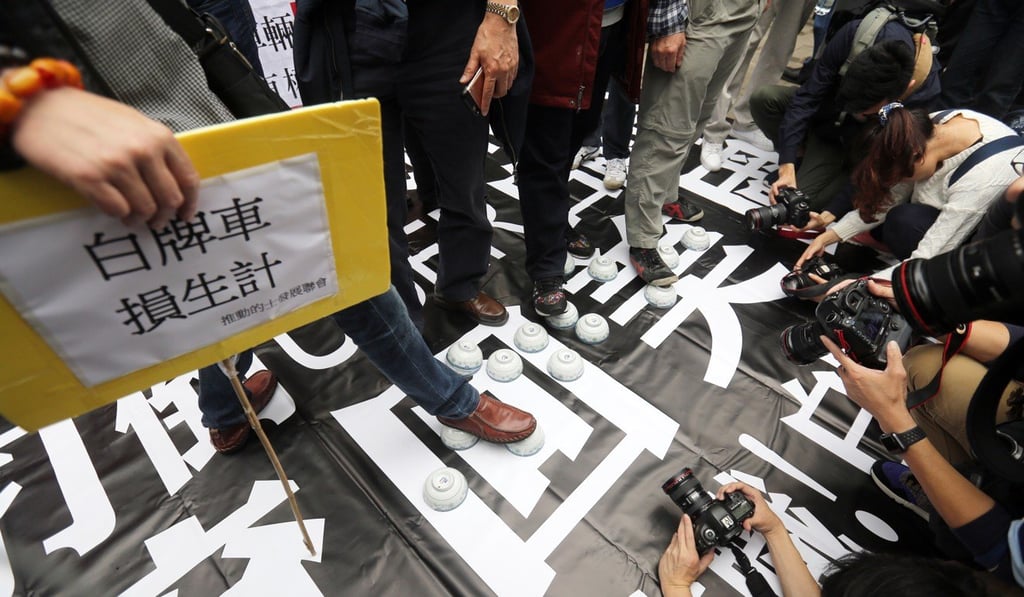 The protesters laid out rice bowls in reference to the threat unlicensed drivers posed to their livelihood. Photo: Xiaomei Chen