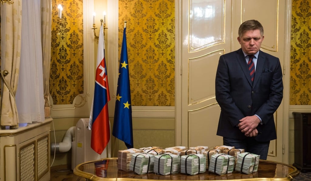 Slovak Prime Minister Robert Fico stands behind bundles of banknotes during a press conference during which he offered his resignation, after the murder of a leading journalist who investigated high-profile tax fraud and political corruption. Photo: AFP Slovak Prime Minister Robert Fico stands behind bundles of banknotes during a press conference during which he offered his resignation, after the murder of a leading journalist who investigated high-profile tax fraud and political corruption. Photo: AFP