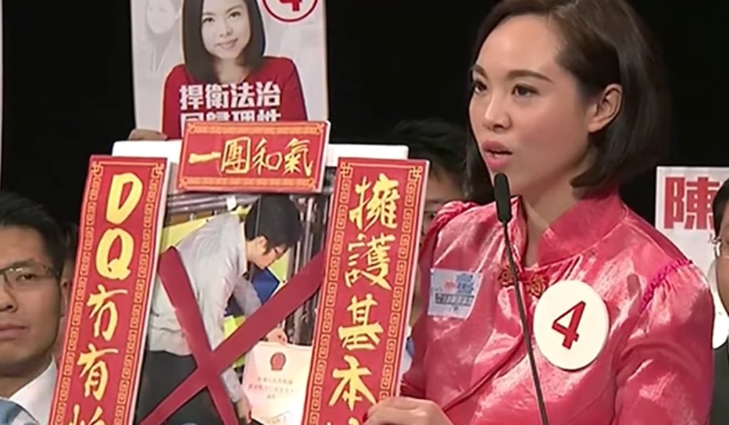 Judy Chan Ka-pui shows an image of Au Nok-hin burning a copy of the Basic Law, in a televised debate. Photo: Facebook