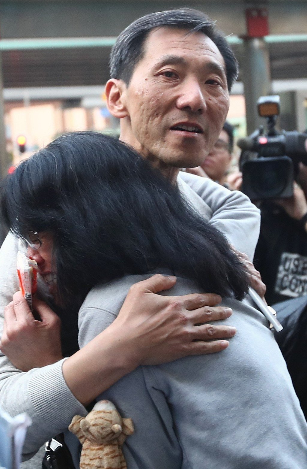 Edward Yiu, who lost the Kowloon West constituency for the Legislative Council by-election, embraces one of his voters to thank her for her support at Mei Foo. Photo: Nora Tam