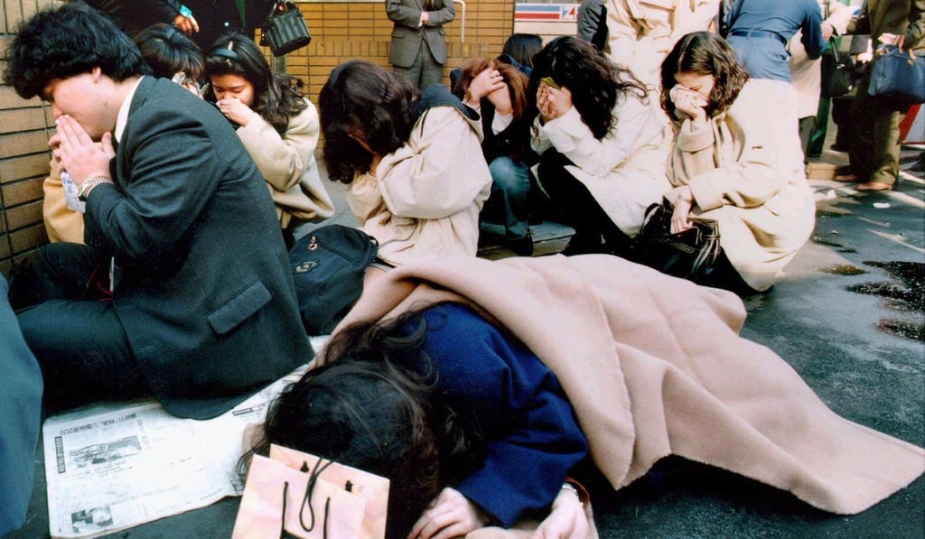Commuters collapse outside a Tokyo subway station on March 20, 1995 following a nerve gas attack. Photo: Reuters