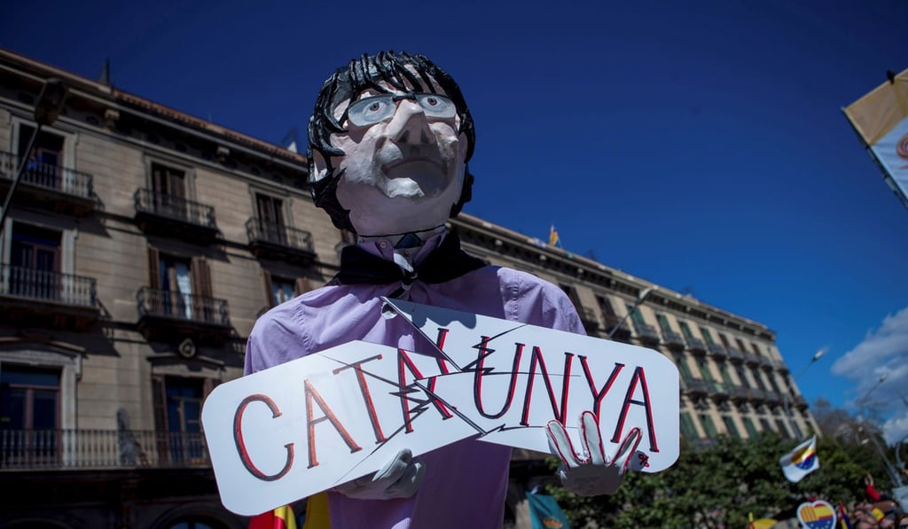 An effigy depicting former Catalan President Carles Puigdemont is seen as thousands of people take part in the demonstration called by Societat Civil Catalana (SCC) under the motto 'Now more than ever, common sense' to denounce the political blockage in Catalonia, in Barcelona, Spain, on March 18, 2018. Photo: EPA-EFE