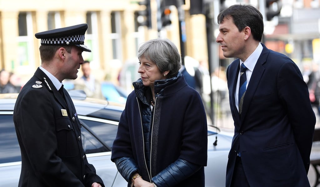 Britain's Prime Minister Theresa May talks to police officers in Salisbury, southern England, on March 15. Former Russian spy Sergei Skripal and his daughter are in a critical condition in hospital after they were reportedly poisoned by a nerve agent. Britain has expelled 23 Russian diplomats over the incident. Photo: AFP