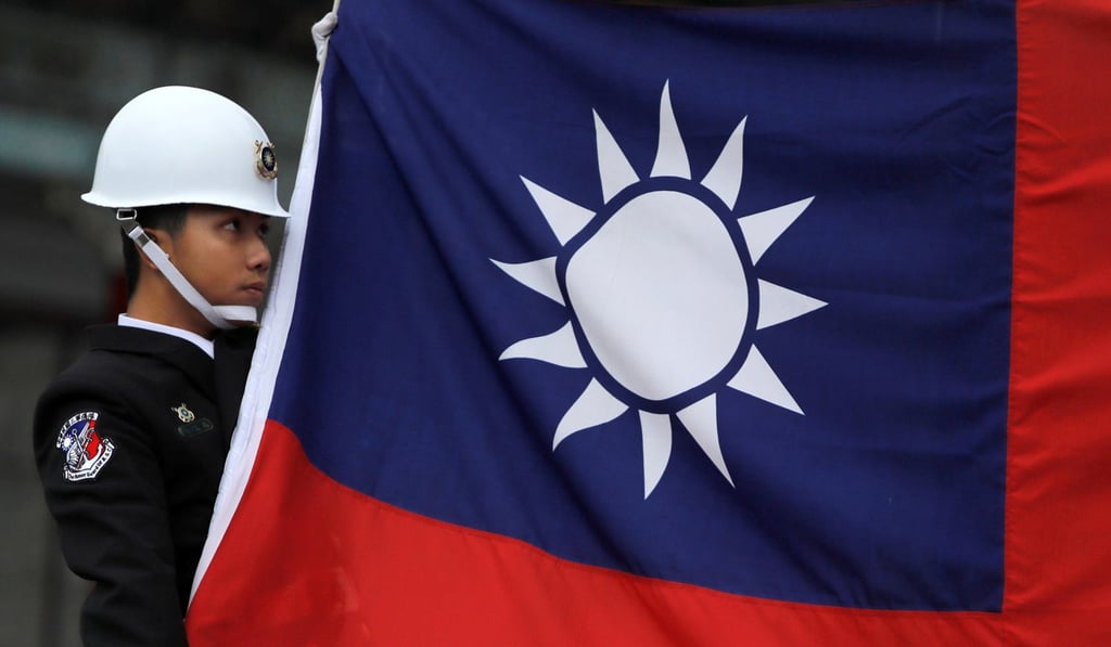 A military honour guard holds a Taiwanese flag while attending a flag-raising ceremony at the Chiang Kai-shek Memorial Hall in Taipei earlier this month. Photo: Reuters