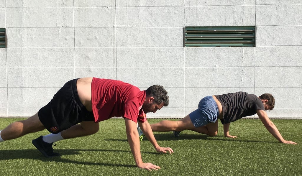 Jonathan White (left) and Sam Agars bear crawl.