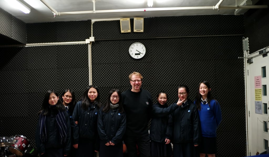 Linder with the Ravens. (from left: Rachel Leung, Sheena Chan, Katie Kam and Candy Lau) and other members of the Rock Club at Jockey Club Ti-I College.