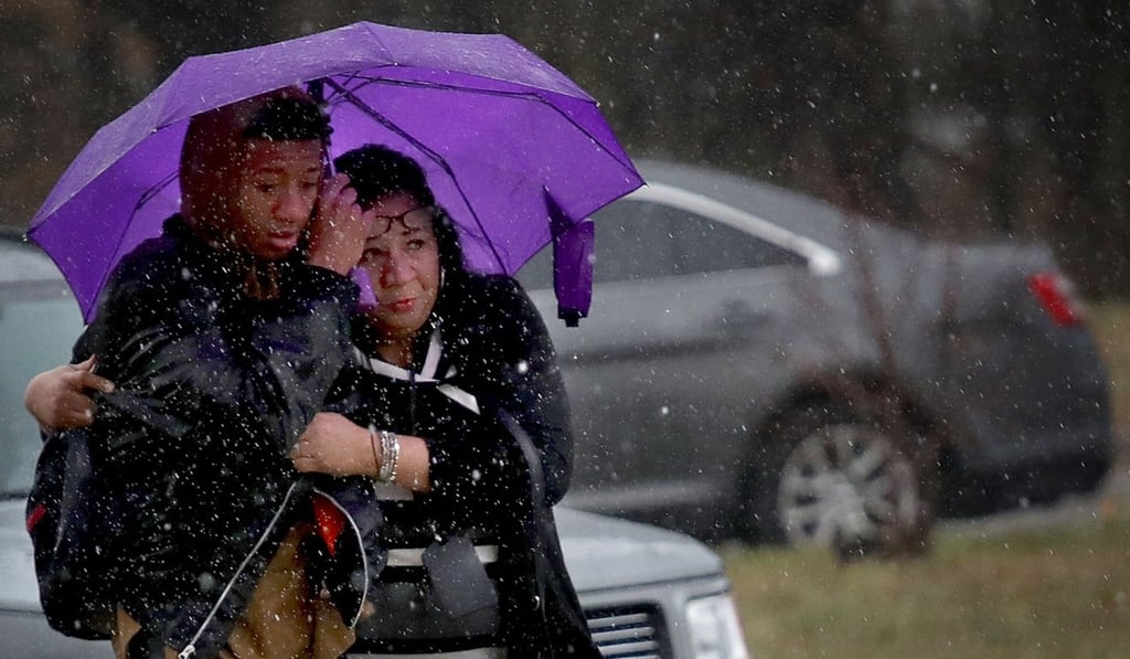 A student from Great Mills High School is comforted by a guardian while being picked up at Leonardtown High School, where pupils were evacuated following a school shooting at Great Mills High School on Tuesday morning. Photo: Getty Images via AFP