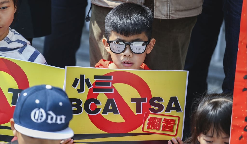 Children and their parents protest against the Territory-wide System Assessment (TSA) outside the government headquarters in Tamar, on February 11. Last week, the government announced changes to the test that are aimed at easing pressure on students and schools. Photo: Nora Tam