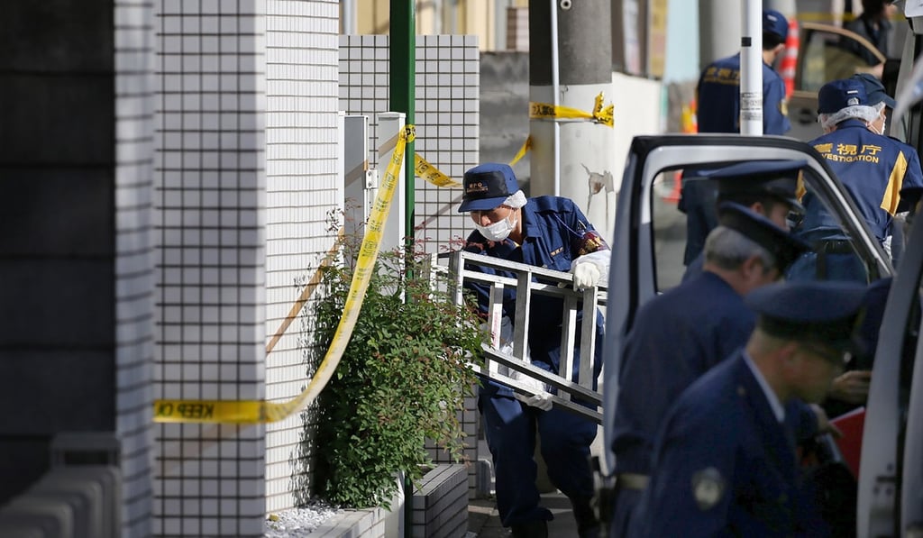 Policemen prepare to inspect the apartment in Zama, Kanagawa prefecture, on November 2, 2017, where the nine dismembered corpses were found. Photo: Jiji Press via AFP