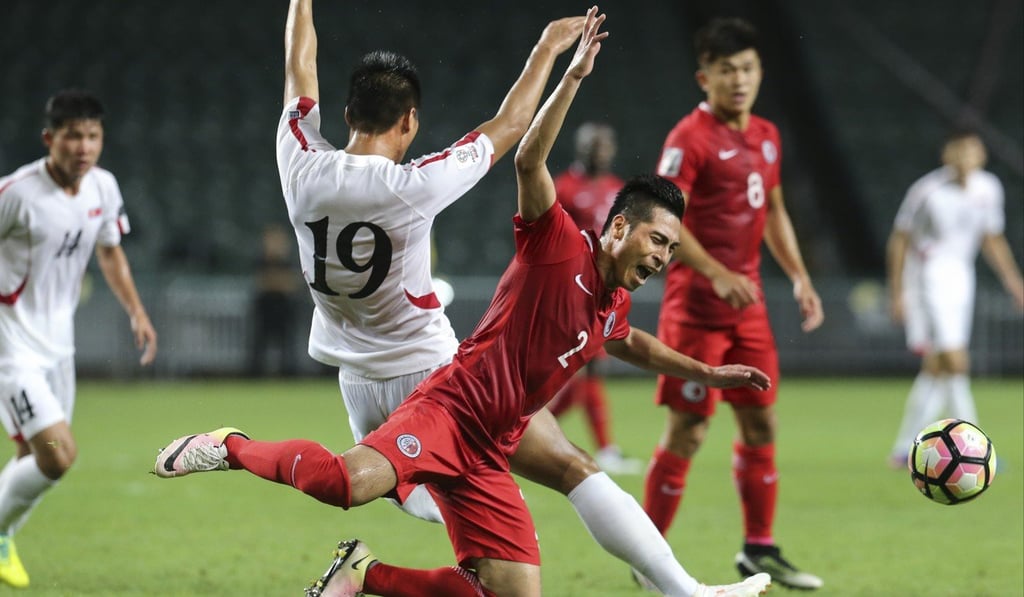 Hong Kong’s Lee Chi-ho (front) is challenged by Pak Kwang-ryong in the reversal at Hong Kong Stadium in June. Photo: Felix Wong