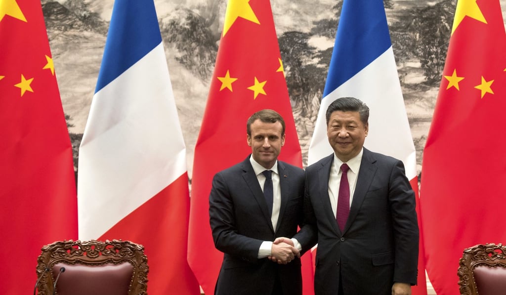French President Emmanuel Macron and President Xi Jinping shake hands at the Great Hall of the People in Beijing in January 2018. Photo: Mark Schiefelbein / AP