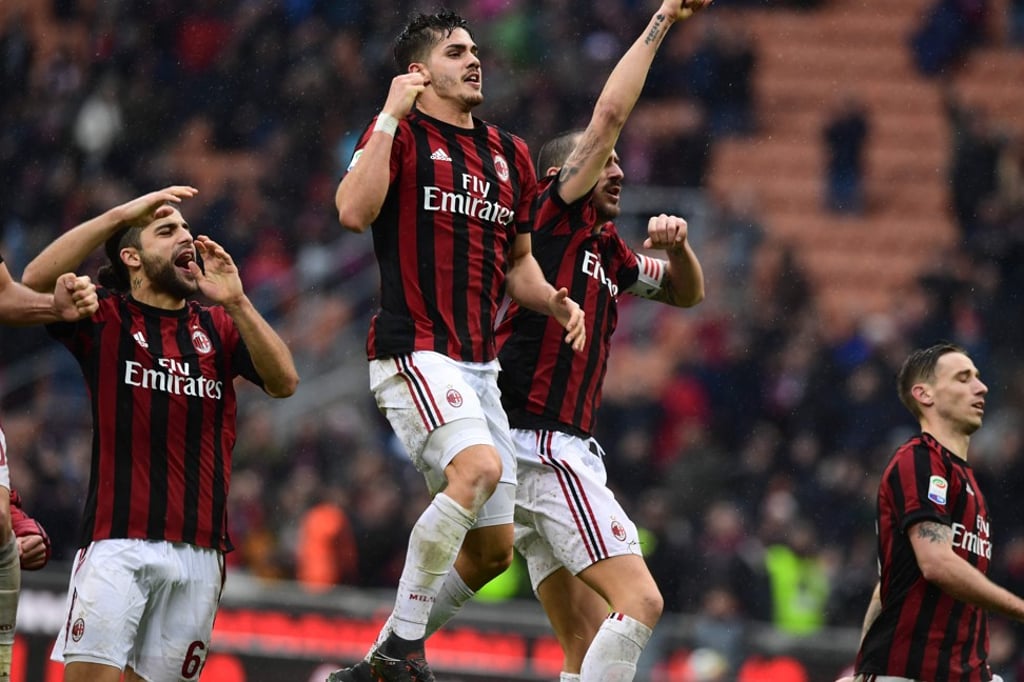 AC Milan’s Portuguese forward Andre Silva (centre) celebrates with his teammates after their win against Chievo at the San Siro. Photo: AFP