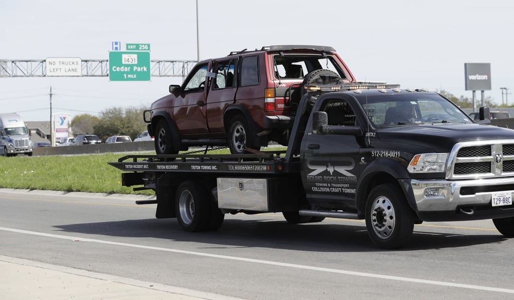 Officials remove the car in which Austin bomber Mark Conditt blew himself up as authorities closed in on Wednesday. Photo: AP