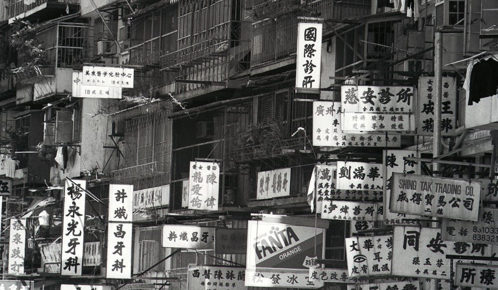 Signboards battle for attention in the cramped Kowloon Walled City. Photo: SCMP Signboards battle for attention in the cramped Kowloon Walled City. Photo: SCMP