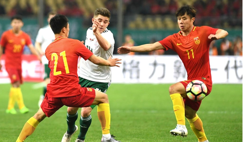 The hapless China defence was breached six times by Wales in the China Cup clash. Photo: Xinhua The hapless China defence was breached six times by Wales in the China Cup clash. Photo: Xinhua