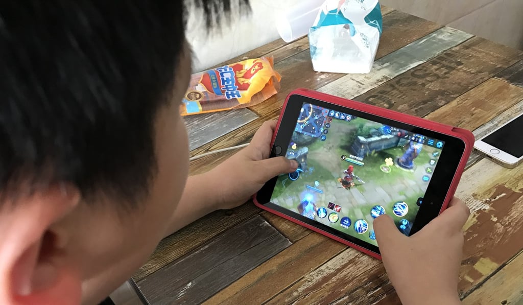 A boy plays Honour of Kings, China’s most popular smartphone game developed by Tencent Holdings. Photo: Simon Song